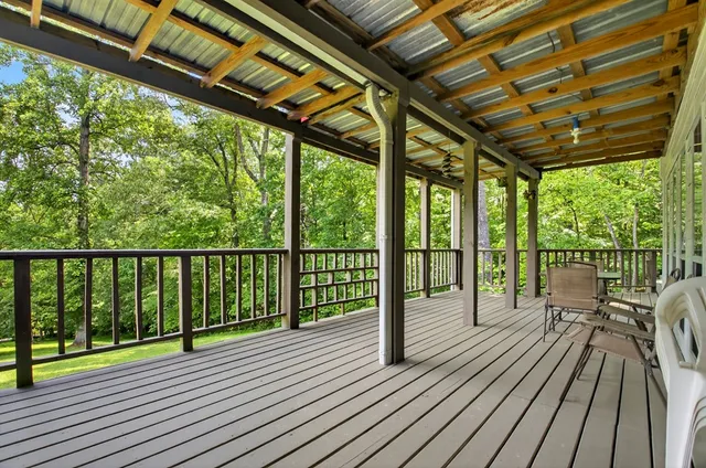 a view of a lush green forest with trees and some houses