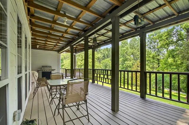 an aerial view of residential house with outdoor space and trees all around
