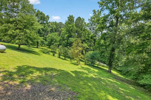 an aerial view of a house with yard and sitting area