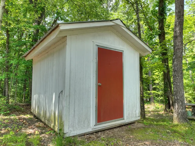 a view of a house with backyard sitting area and garden
