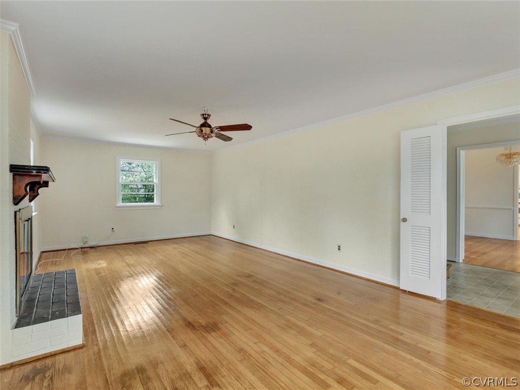 606 Heathfield Road Henrico, VA 23229 - Photo 6 of 35 an empty room with wooden floor cabinet and windows