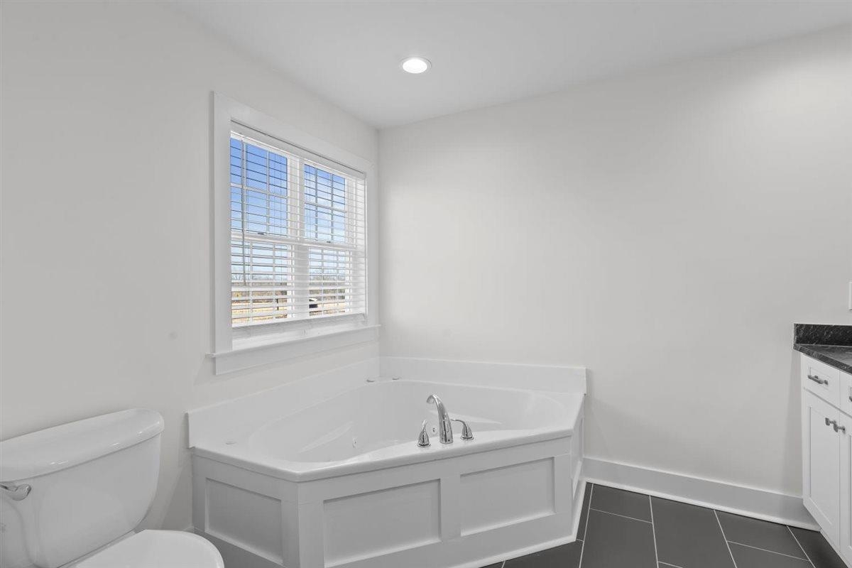 620 Diffee Road Moscow, TN 38057 - Photo 14 of 40 Full bath featuring a garden tub, vanity, recessed lighting, and dark tile patterned floors