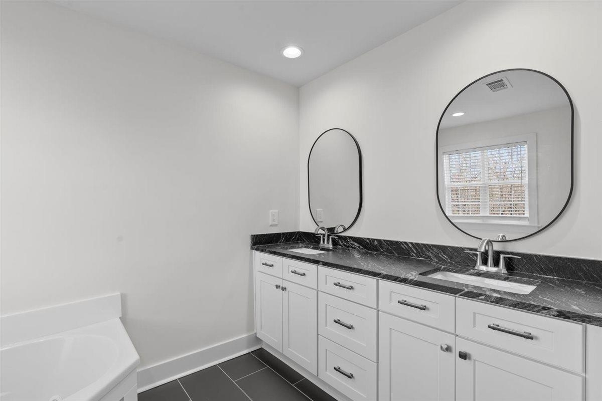 620 Diffee Road Moscow, TN 38057 - Photo 16 of 40 Bathroom featuring double vanity, a garden tub, recessed lighting, and dark tile patterned flooring