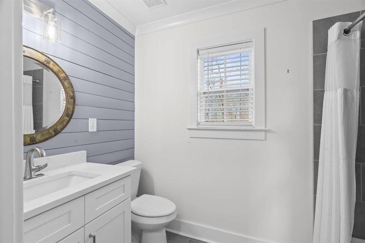 620 Diffee Road Moscow, TN 38057 - Photo 26 of 40 Full bathroom featuring curtained shower, vanity, wooden walls, and crown molding
