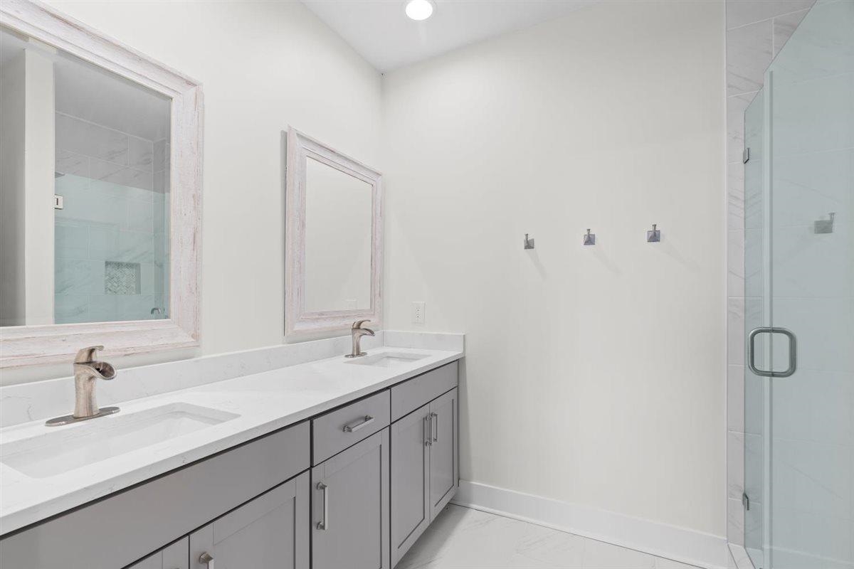 620 Diffee Road Moscow, TN 38057 - Photo 29 of 40 Full bathroom featuring a stall shower, double vanity, and light marble finish floors