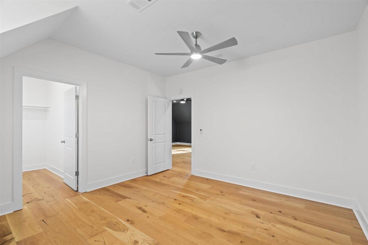 620 Diffee Road Moscow, TN 38057 - Photo 32 of 40 Unfurnished bedroom featuring light wood-type flooring, a walk in closet, and ceiling fan