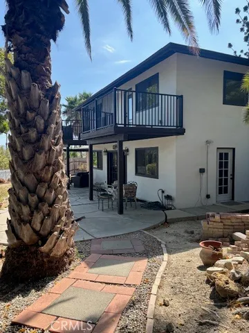 a backyard of a house with barbeque oven