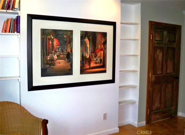 a view of a hallway with wooden floor and closet