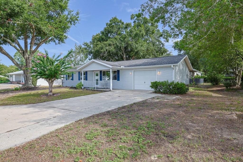 8657 Southwest 116th Lane Road Ocala, FL 34481 - Photo 1 of 1 a front view of a house with a yard and garage