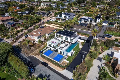 an aerial view of residential houses with outdoor space