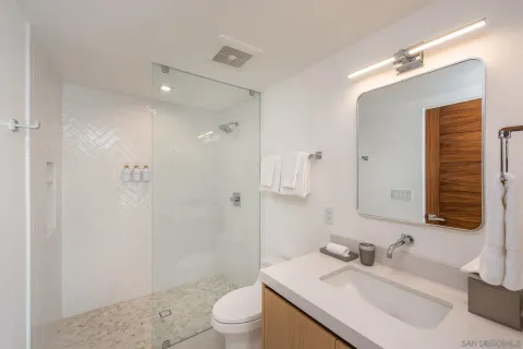 a bathroom with a sink toilet and shower