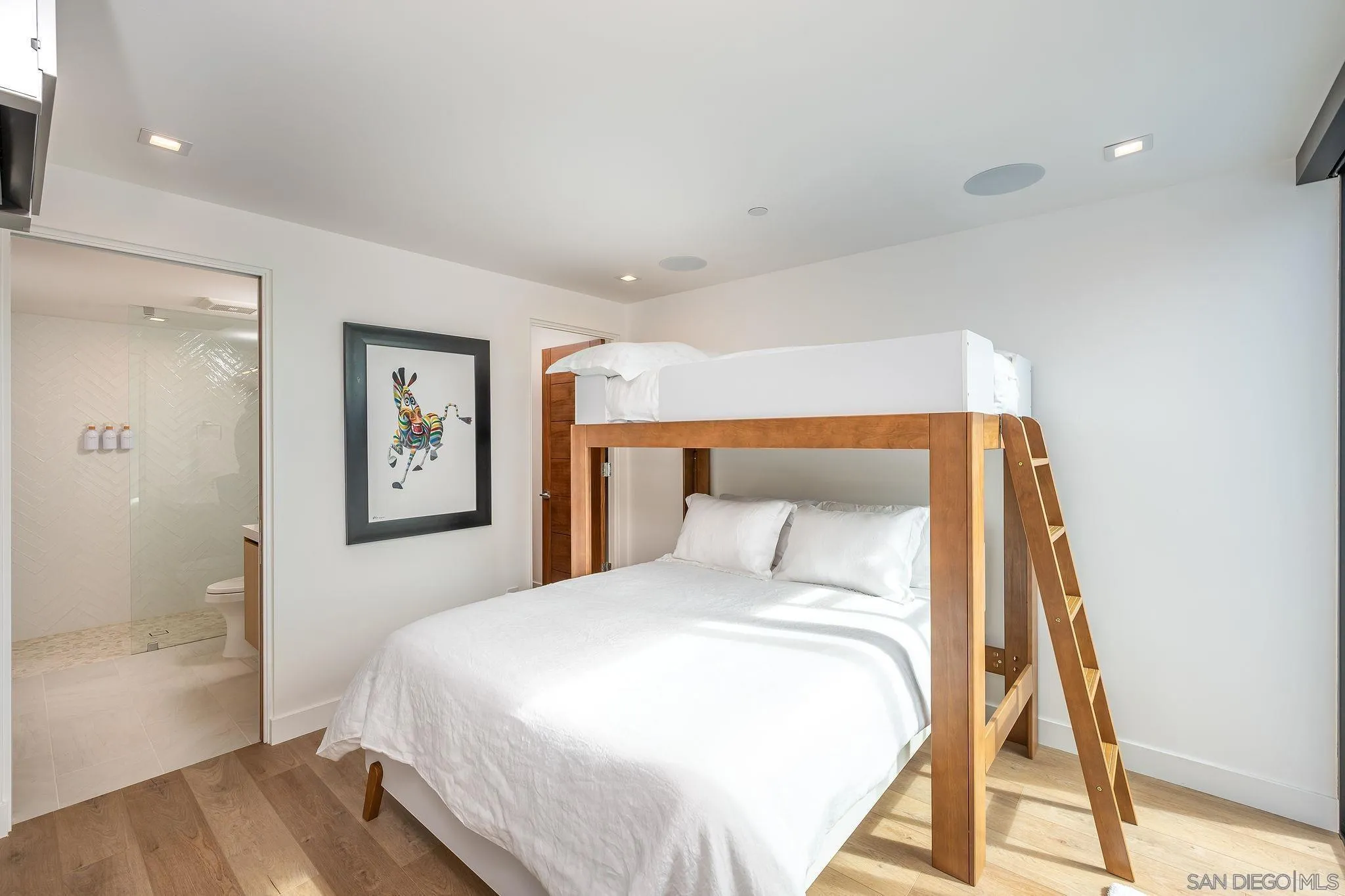 1605 Burgundy Road Encinitas, CA 92024 - Photo 26 of 49 a bedroom with a bed and wooden floor