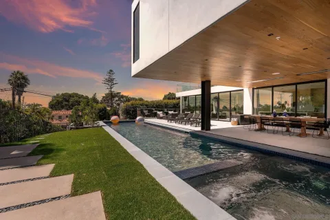 a swimming pool with outdoor seating and yard