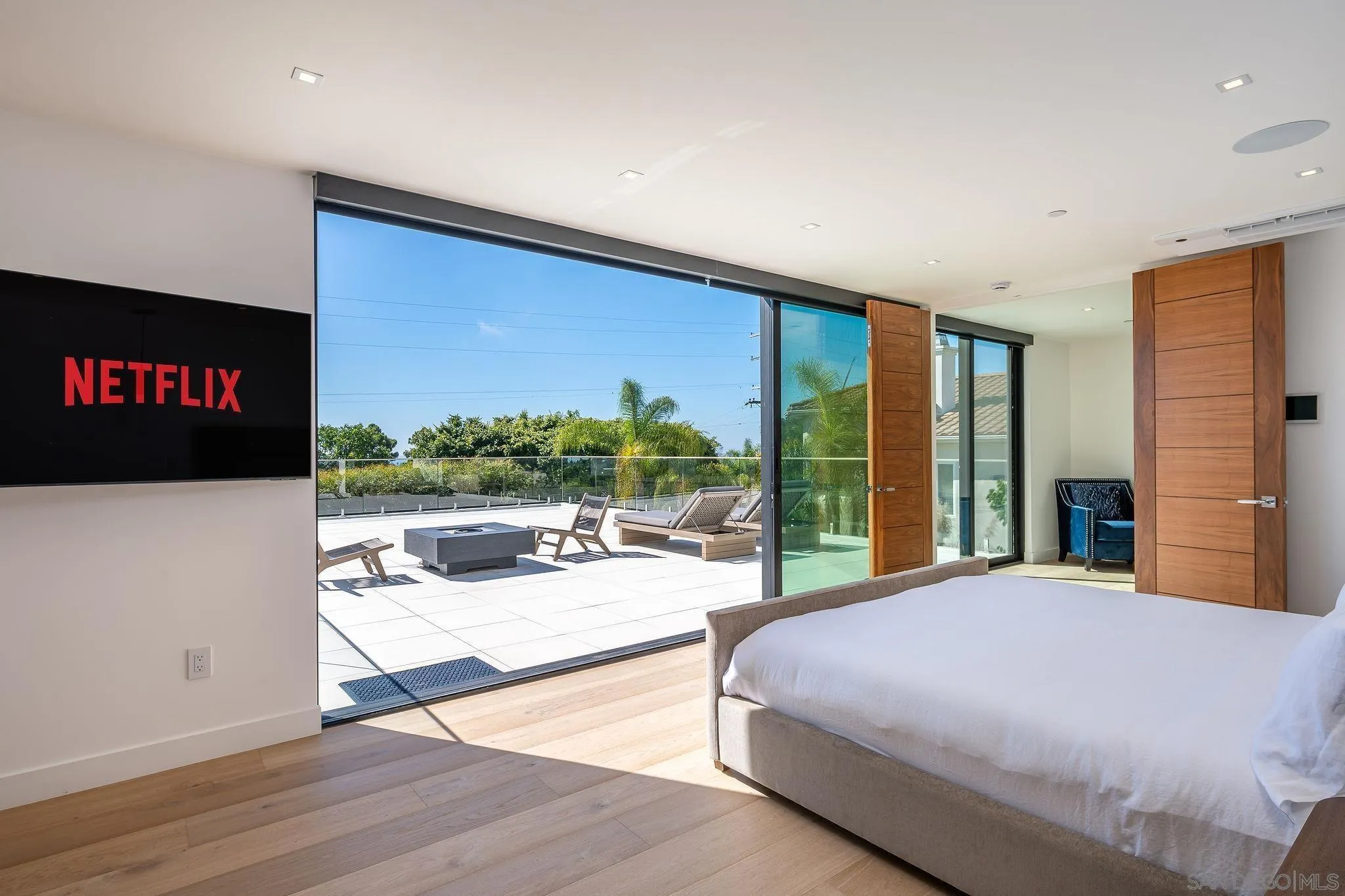 1605 Burgundy Road Encinitas, CA 92024 - Photo 31 of 49 a bedroom with a bed and glass windows