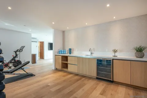 a large white kitchen with sink and cabinets