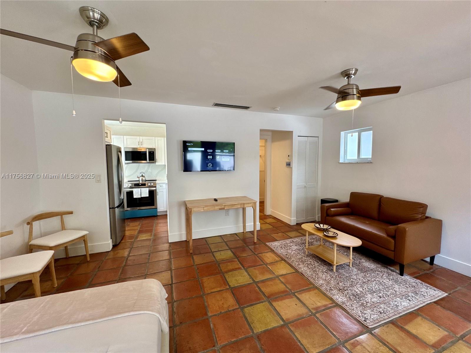 2918 Bird Avenue, Unit 8 Miami, FL 33133 - Photo 1 of 11 a living room with furniture and a rug