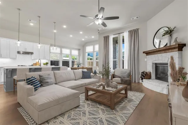 a living room with furniture a fireplace and a chandelier