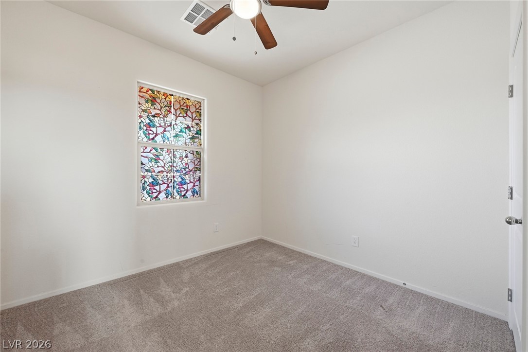 250 Dedication Avenue Henderson, NV 89011 - Photo 35 of 67 Carpeted spare room featuring baseboards and a ceiling fan