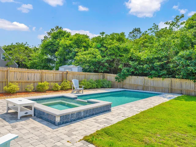 a view of a backyard with swimming pool