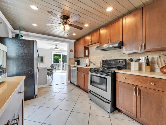 a kitchen with stainless steel appliances granite countertop a stove cabinets and a sink
