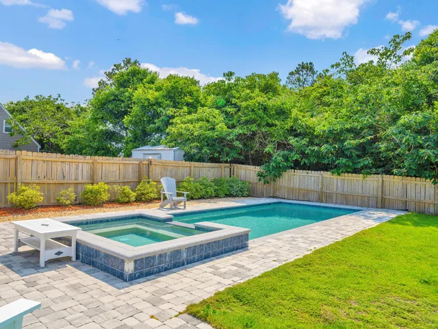 a view of a backyard with swimming pool