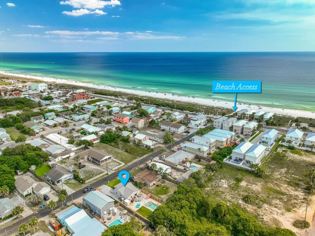 aerial view of a house with a yard and potted plants