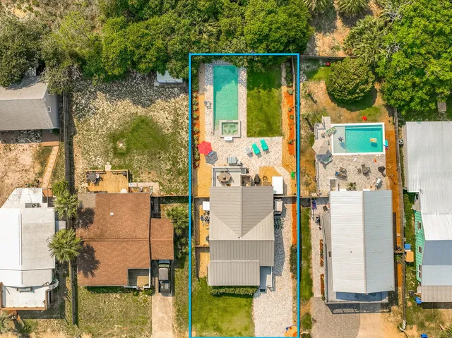 a view of backyard with deck and garden