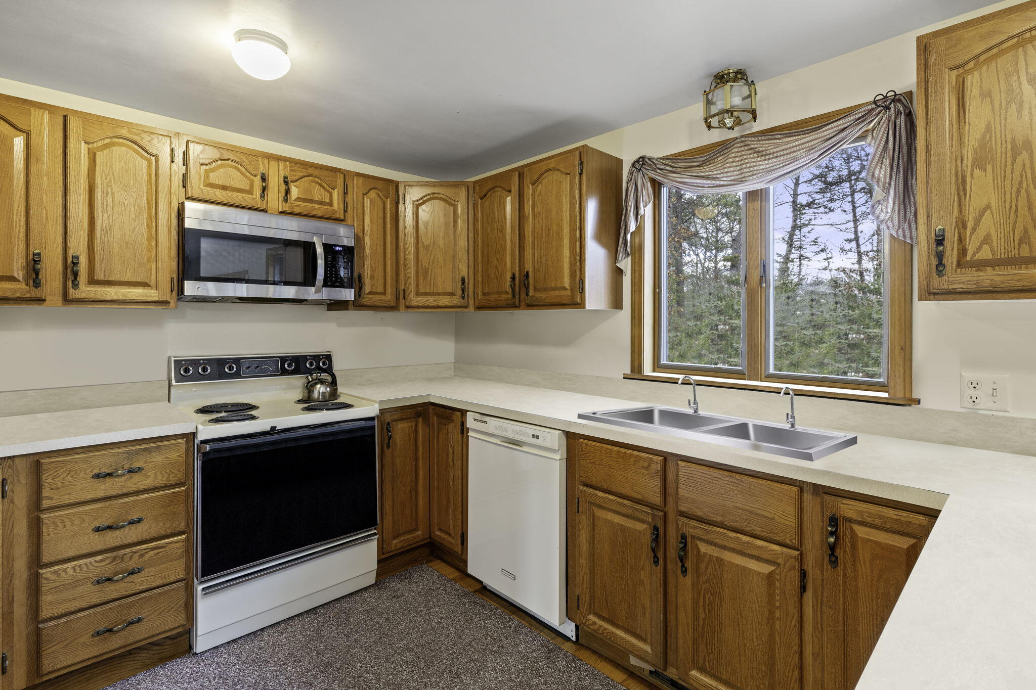 35 Pine Field Road Wellfleet, MA 02667 - Photo 16 of 31 a kitchen with a sink stove and microwave