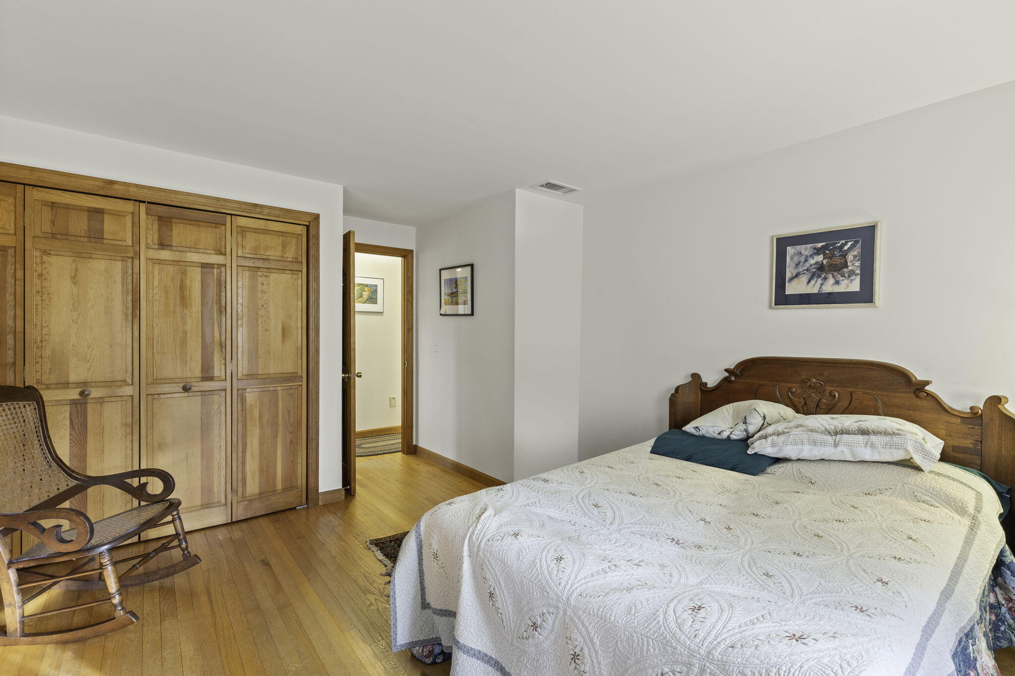 35 Pine Field Road Wellfleet, MA 02667 - Photo 20 of 31 a bedroom with a bed and wooden floor