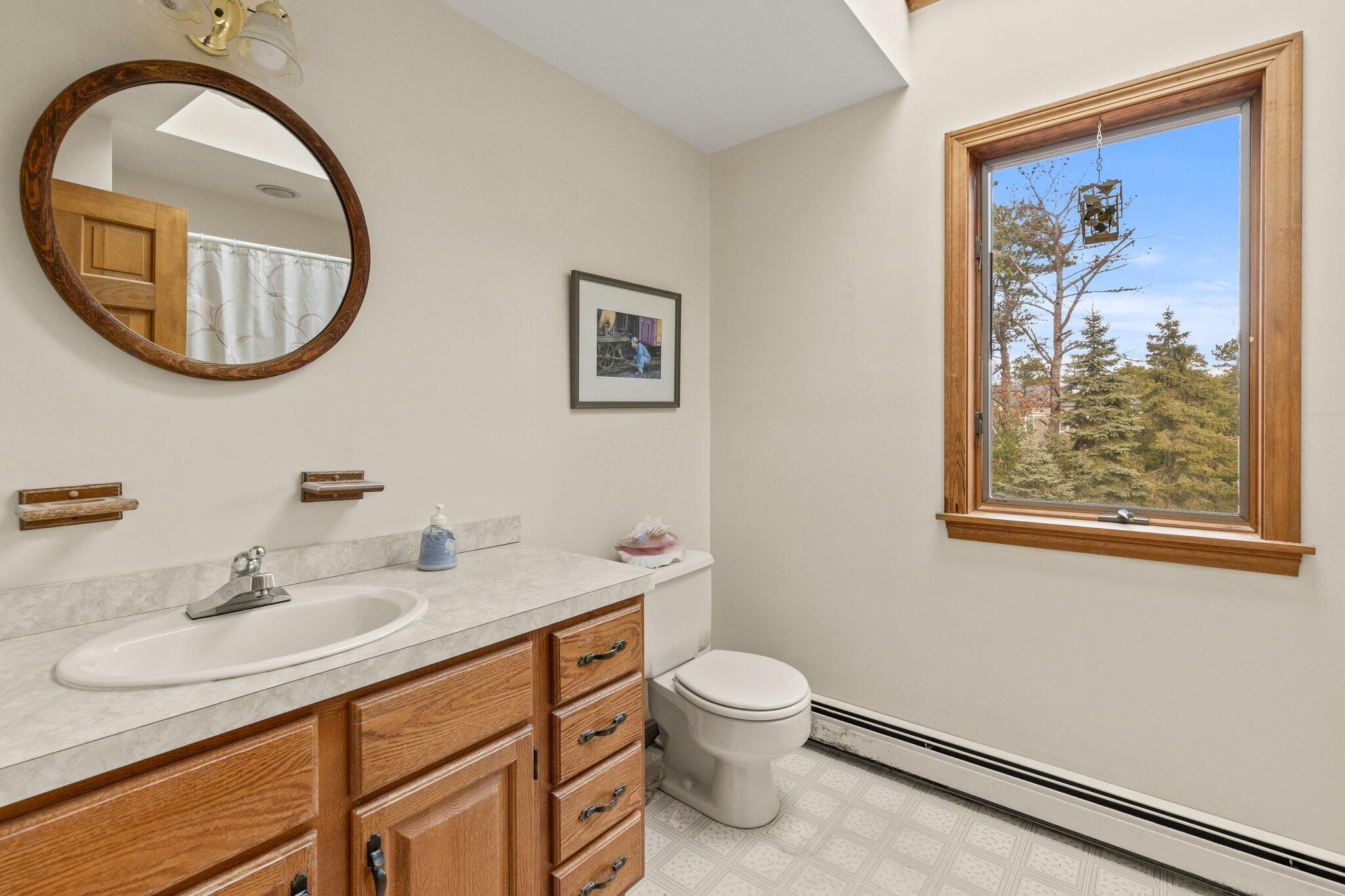 35 Pine Field Road Wellfleet, MA 02667 - Photo 23 of 31 a bathroom with a toilet a sink and a mirror