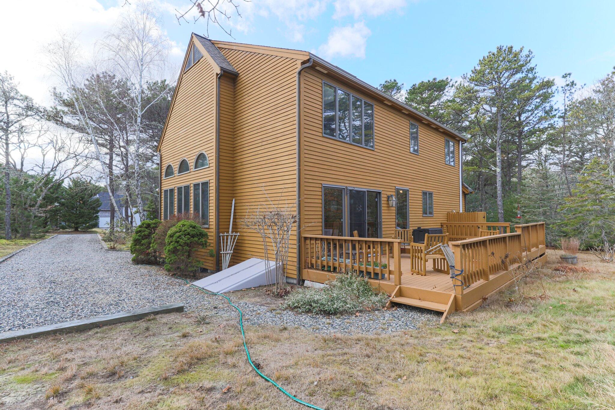 35 Pine Field Road Wellfleet, MA 02667 - Photo 26 of 31 a view of a house with a yard and wooden fence