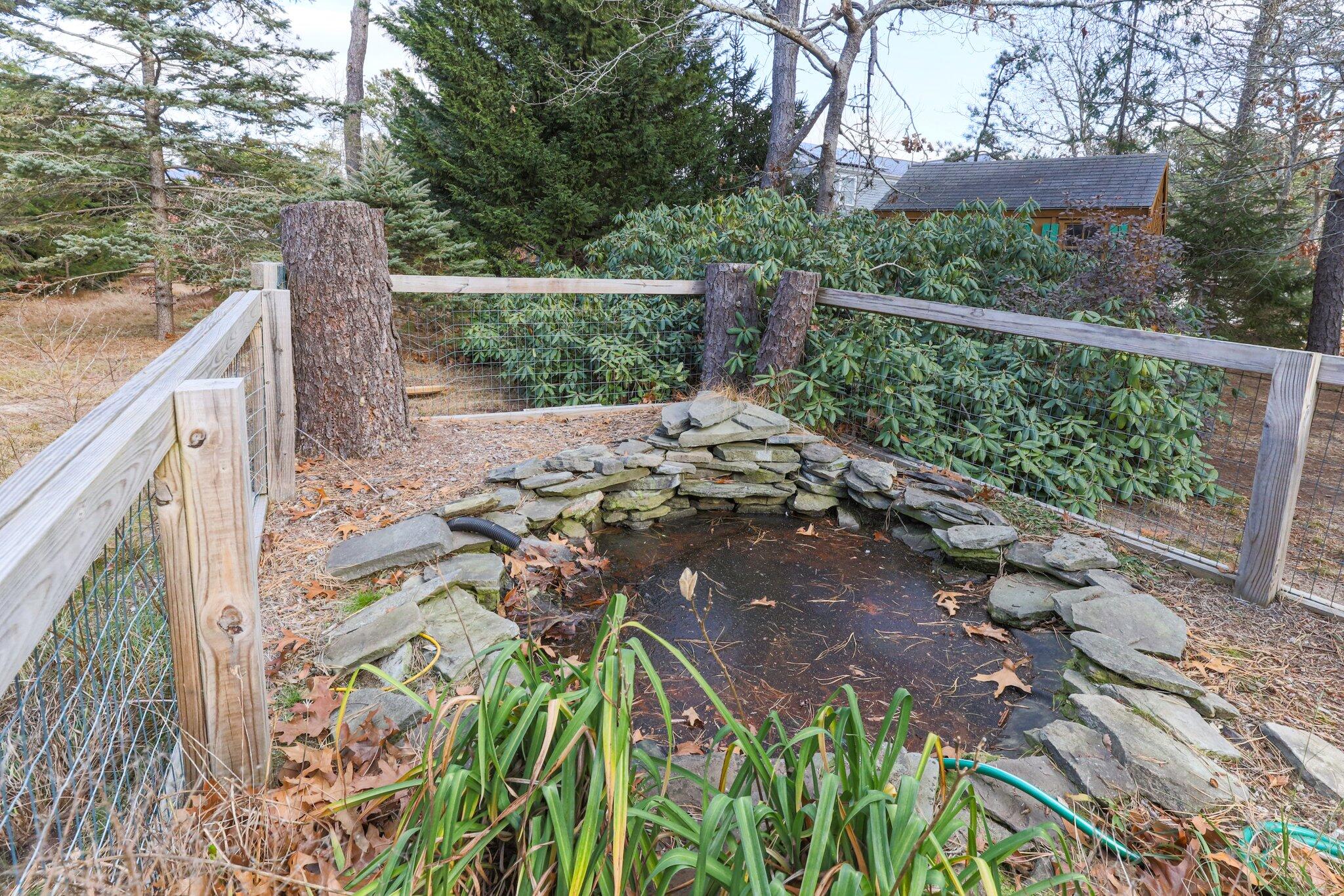 35 Pine Field Road Wellfleet, MA 02667 - Photo 28 of 31 a view of a yard and a fountain in the yard