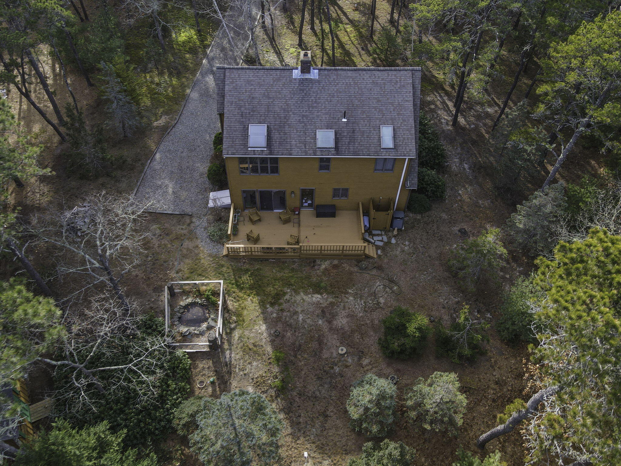 35 Pine Field Road Wellfleet, MA 02667 - Photo 29 of 31 a view of a house with a yard table and chair