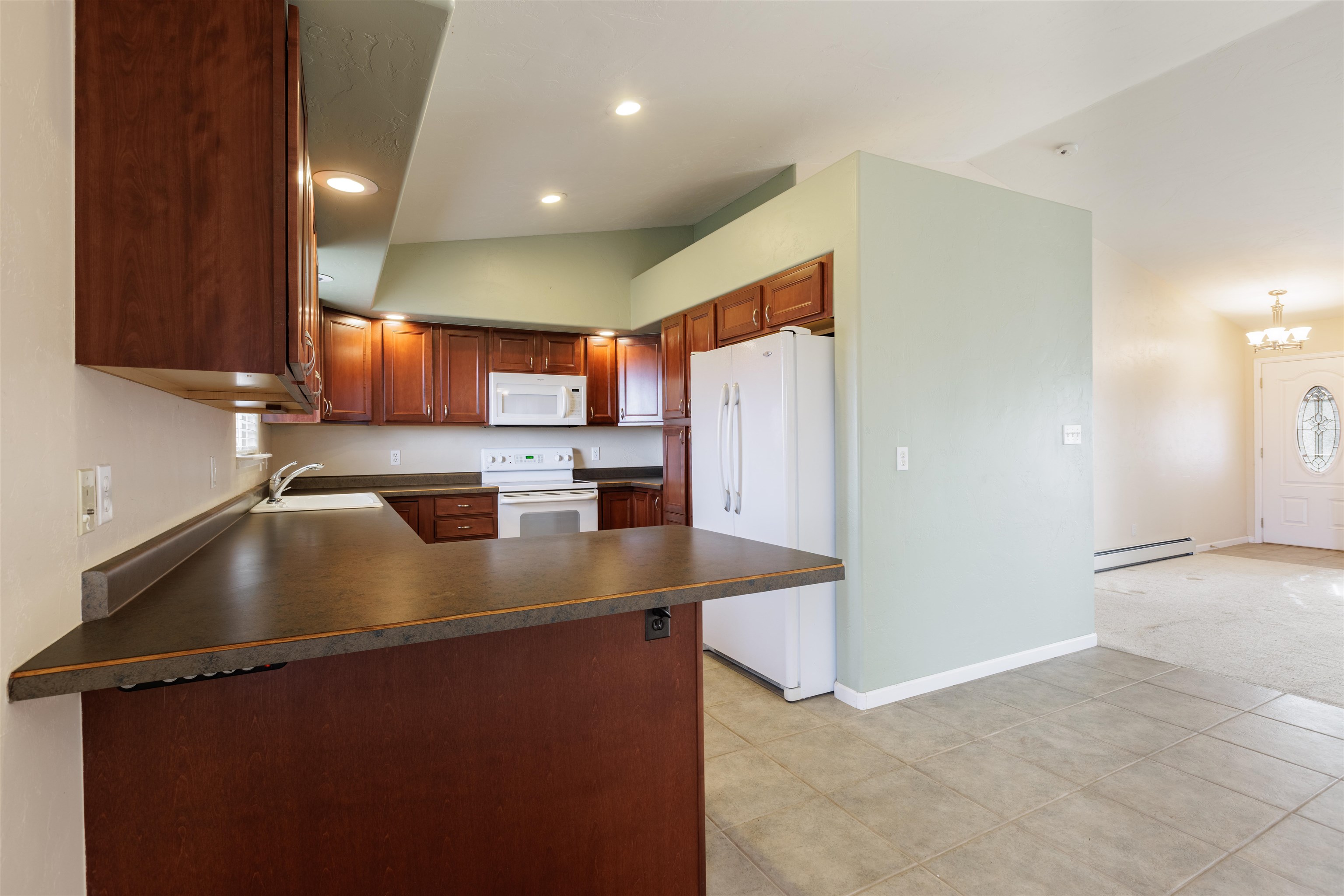 2098 J Road Fruita, CO 81521 - Photo 4 of 13 a view of a kitchen with a sink a counter top space and cabinets