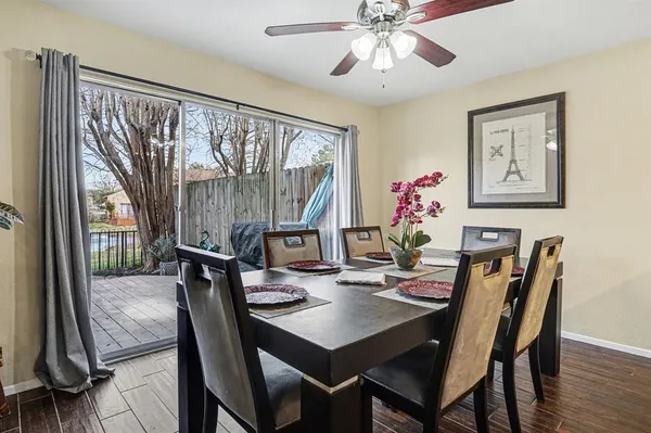 a view of a kitchen with wooden floor and a ceiling fan