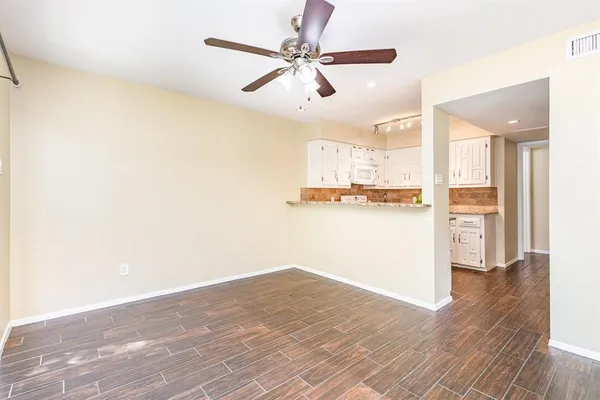 a kitchen with cabinets appliances a sink and a counter top space