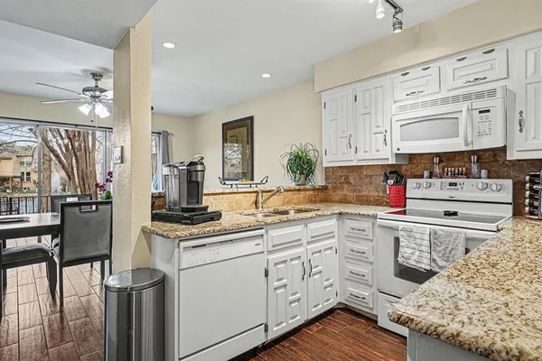 a kitchen with kitchen island a sink stove and refrigerator