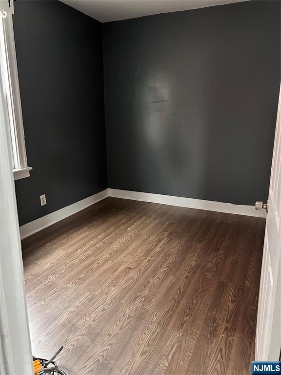 602 Chancellor Avenue Irvington, NJ 07111 - Photo 8 of 13 a view of empty room with wooden floor