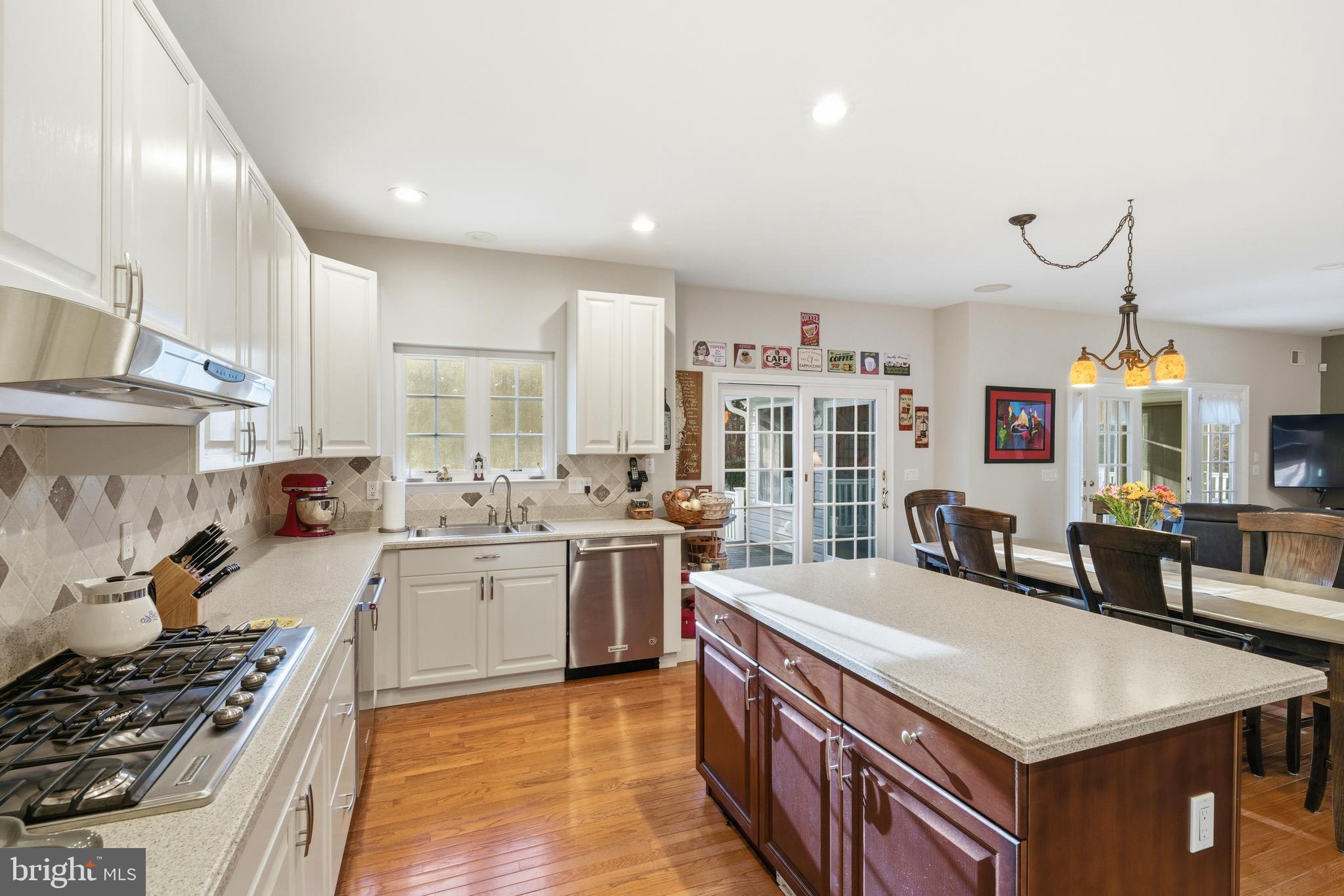 39 Rodeo Drive West Creek, NJ 08092 - Photo 25 of 78 a large kitchen with stainless steel appliances a stove a sink dishwasher and a dining table with the living room view