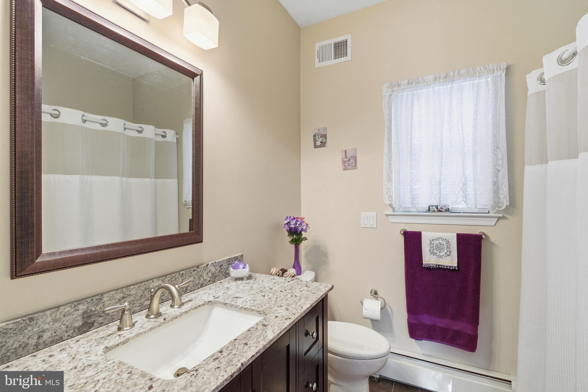 39 Rodeo Drive West Creek, NJ 08092 - Photo 44 of 78 a bathroom with a granite countertop sink a toilet and a mirror
