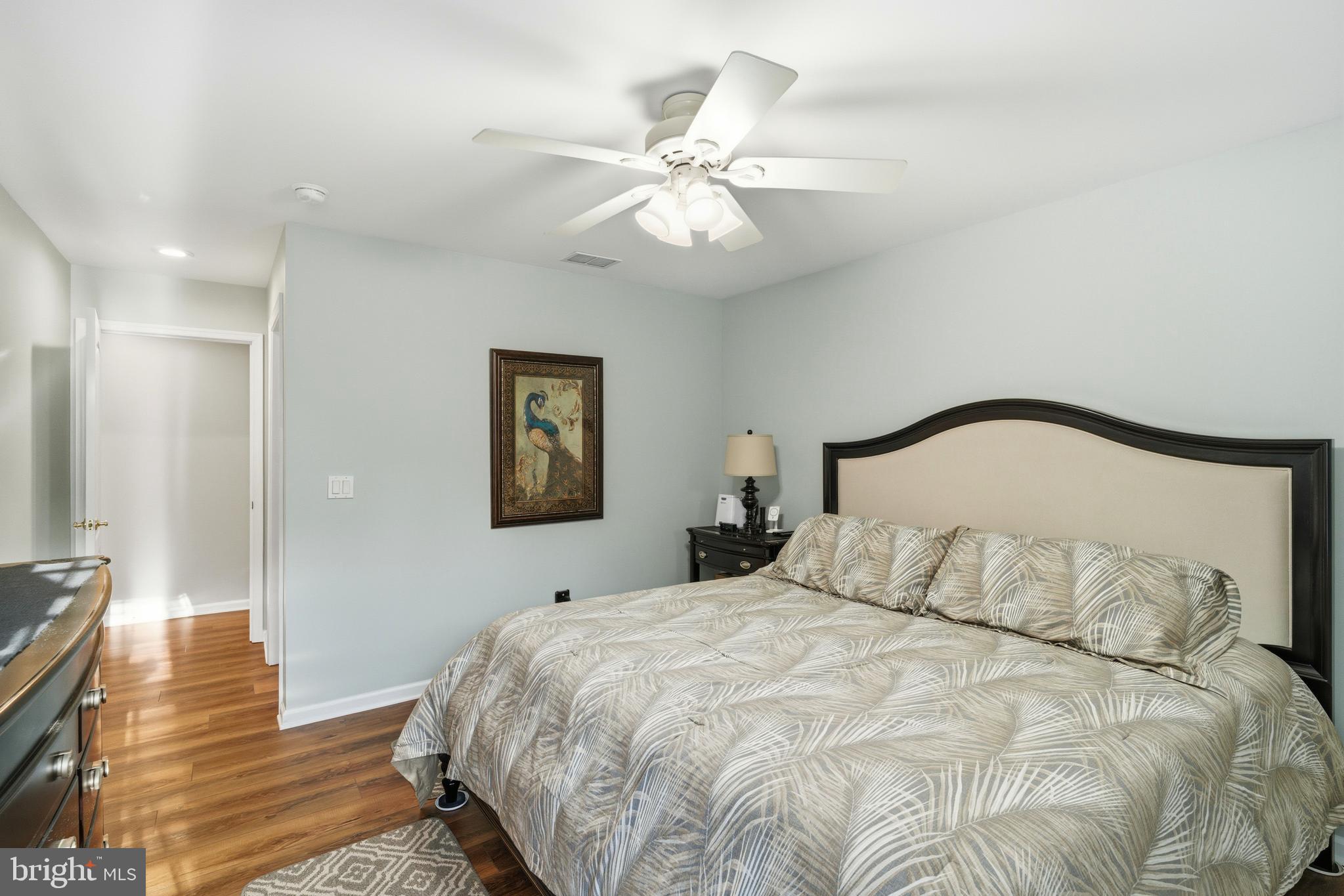 39 Rodeo Drive West Creek, NJ 08092 - Photo 61 of 78 a bedroom with a bed and a chandelier