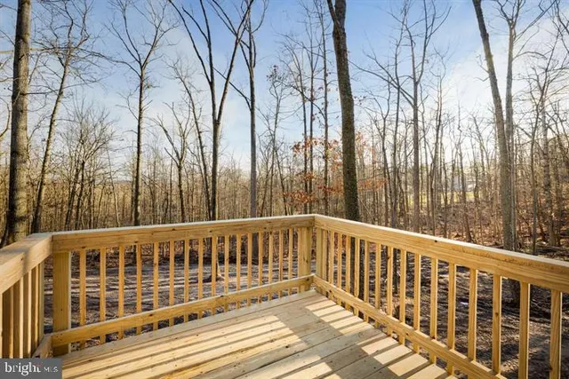 a view of a wooden deck and trees