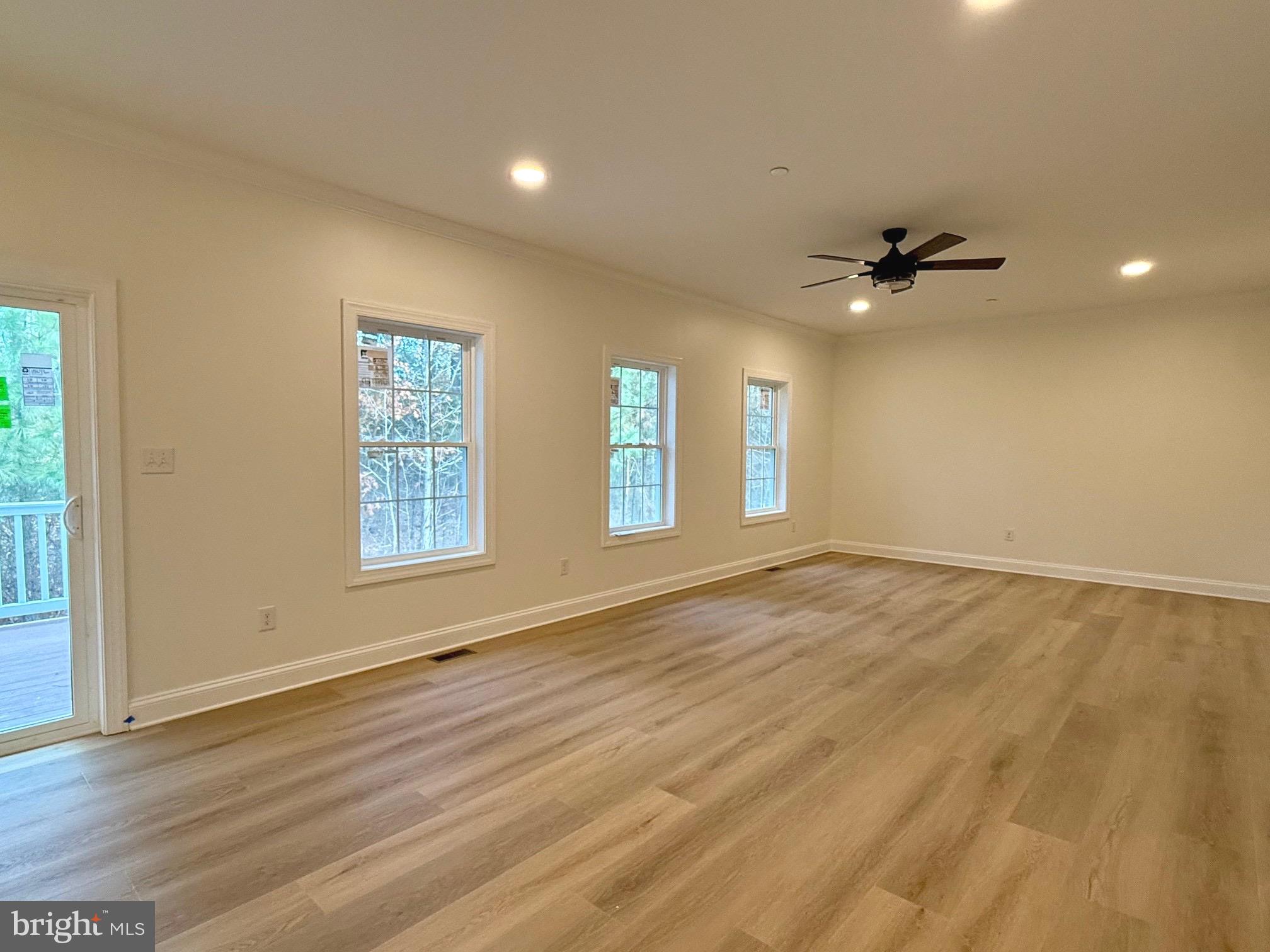 17490 Lighthouse Commons Drive Piney Point, MD 20674 - Photo 11 of 44 an empty room with wooden floor and windows