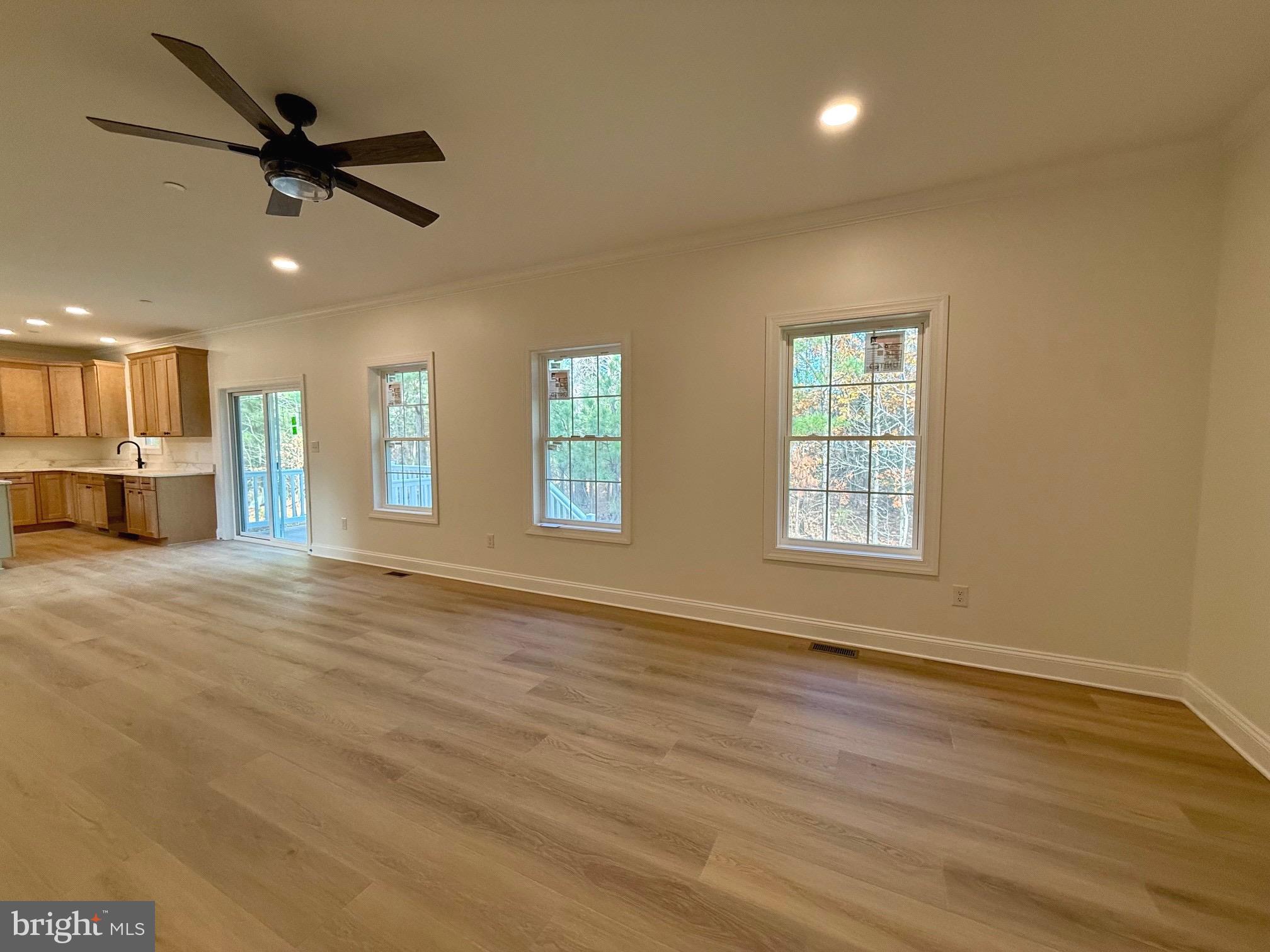 17490 Lighthouse Commons Drive Piney Point, MD 20674 - Photo 12 of 44 a view of an empty room with a window and a kitchen