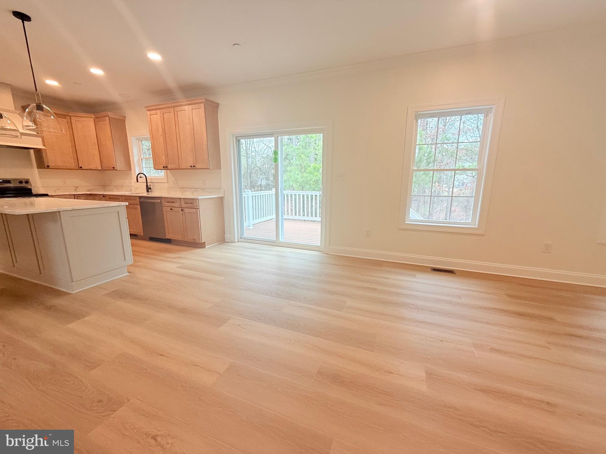 17490 Lighthouse Commons Drive Piney Point, MD 20674 - Photo 14 of 44 a view of a kitchen with a sink wooden cabinets and a window