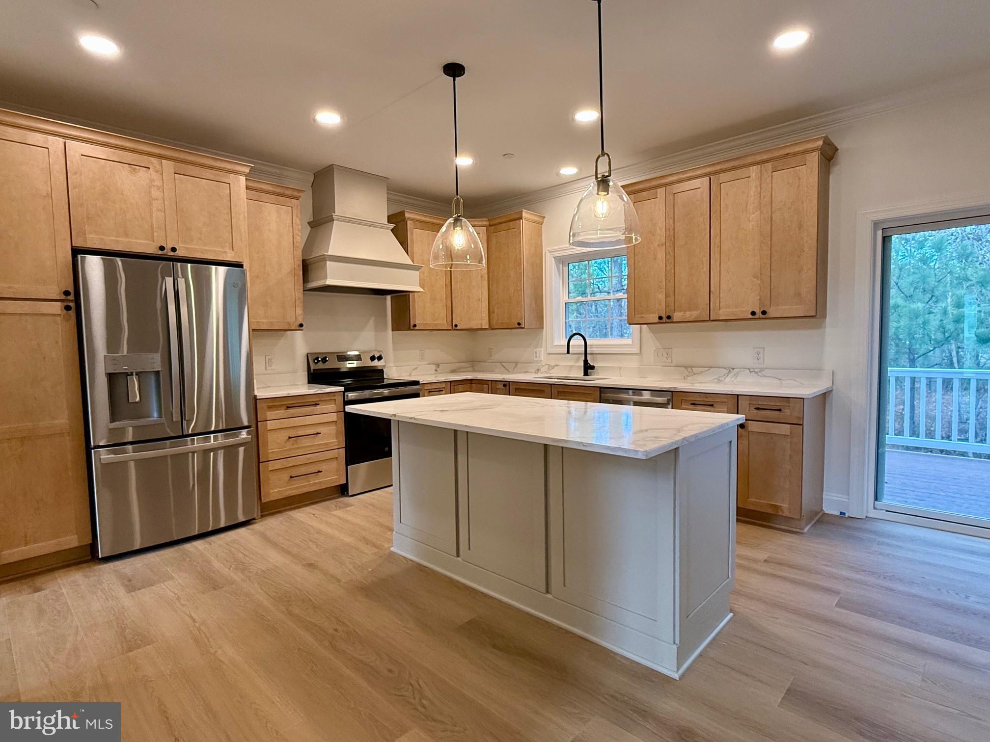 17490 Lighthouse Commons Drive Piney Point, MD 20674 - Photo 17 of 44 a kitchen with a refrigerator a sink and wooden floor