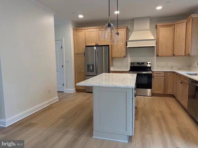 a kitchen with stainless steel appliances granite countertop a sink a stove and a refrigerator