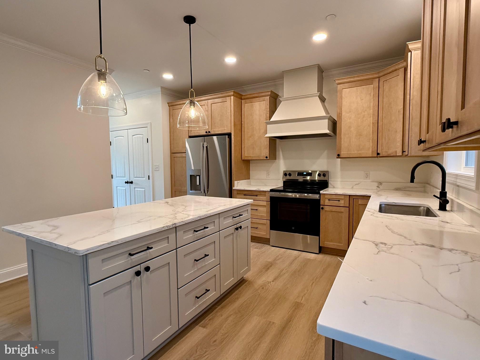 17490 Lighthouse Commons Drive Piney Point, MD 20674 - Photo 19 of 44 a kitchen with kitchen island granite countertop a stove a sink a refrigerator and a wooden floors
