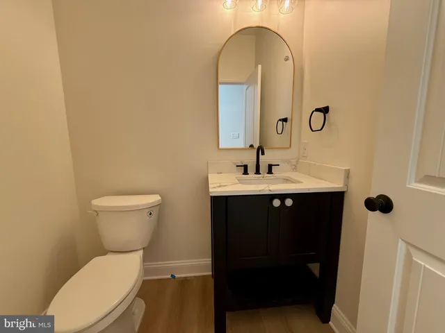 a bathroom with a sink a toilet and a mirror