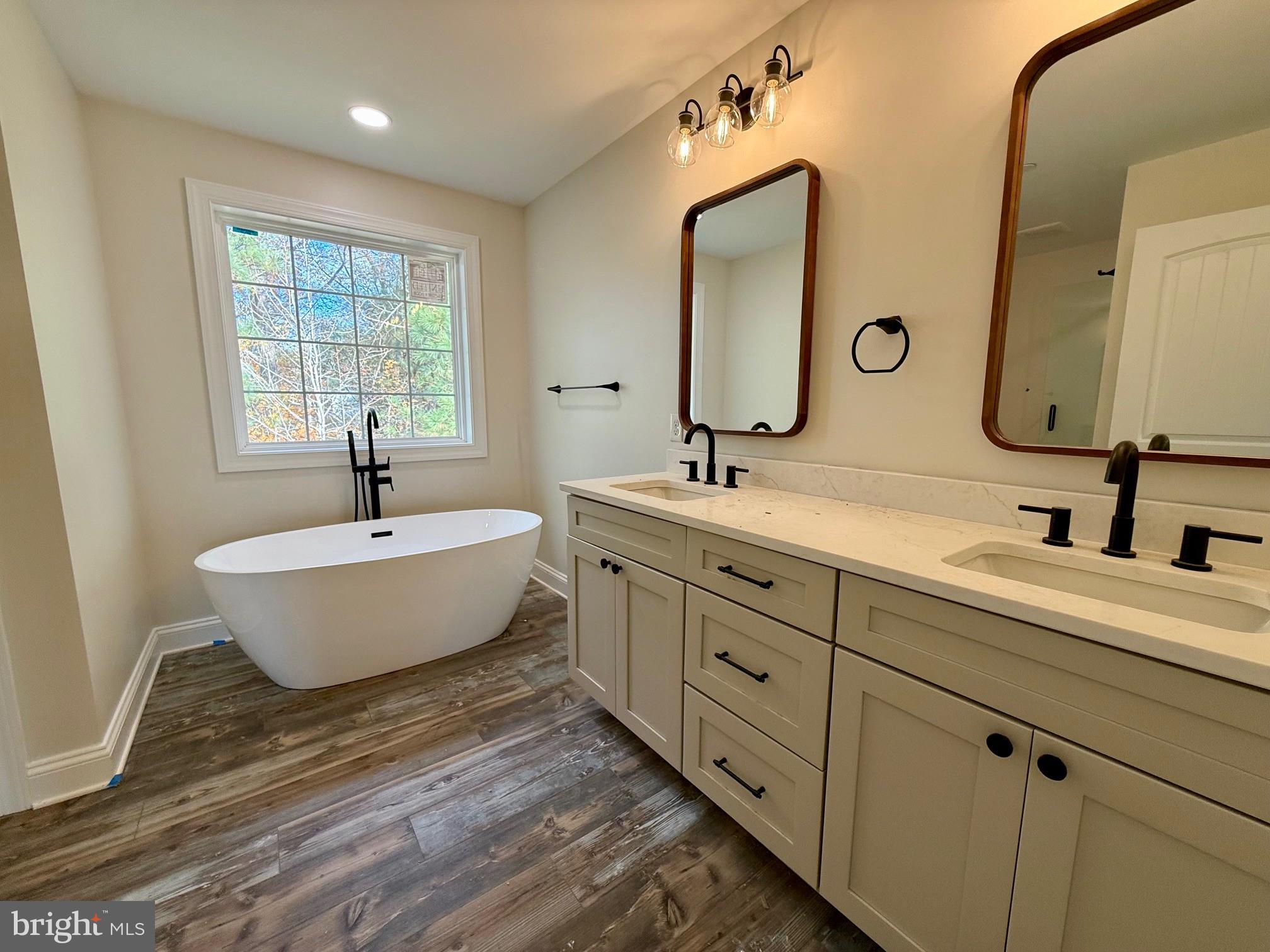 17490 Lighthouse Commons Drive Piney Point, MD 20674 - Photo 29 of 44 a bathroom with double vanity sinks and a mirror